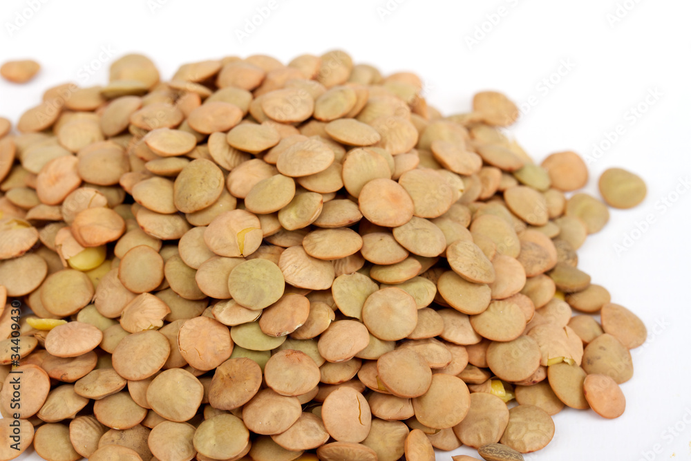 Pile of green lentils from low perspective isolated on white. Pile of green lentils from low perspective isolated on white.