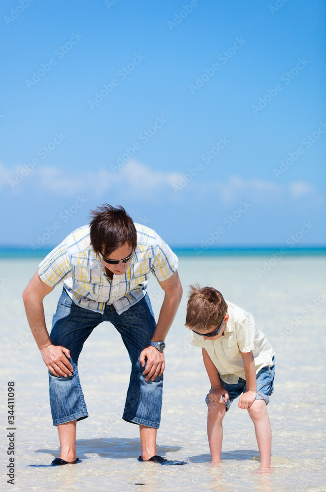Father and son at shallow water