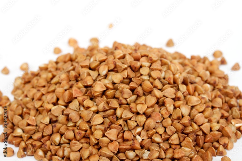 Isolated buckwheat on white background. Handful of grain Isolated buckwheat on white background. Handful of grain