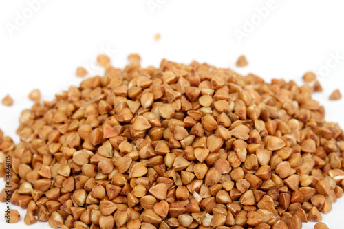 Isolated buckwheat on white background. Handful of grain