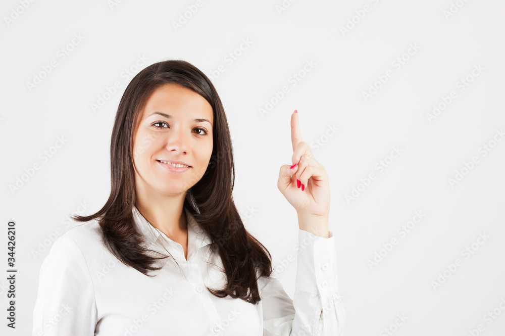 Happy smiling young business woman showing blank area for sign o Happy smiling young business woman showing blank area for sign o