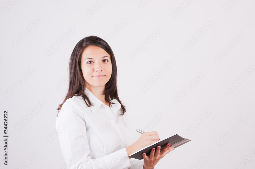 Happy smiling young businesswoman with clipboard writing, Happy smiling young businesswoman with clipboard writing,