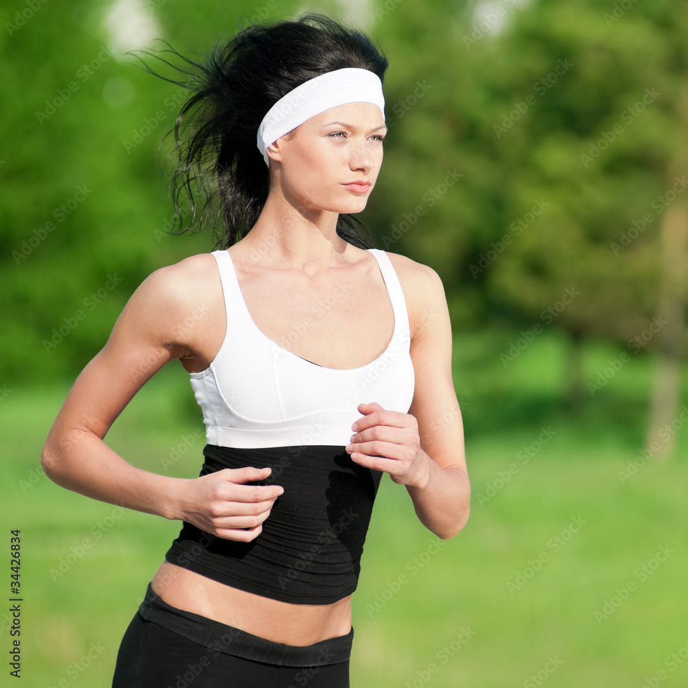 Fototapeta premium Woman running in green park