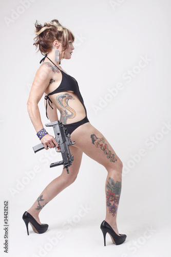 Sexy woman wearing swimsuit with an assault gun