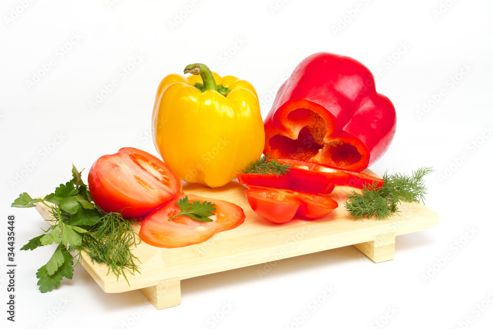 Pepper, tomato with dill and parsley on the wood desk isolated
