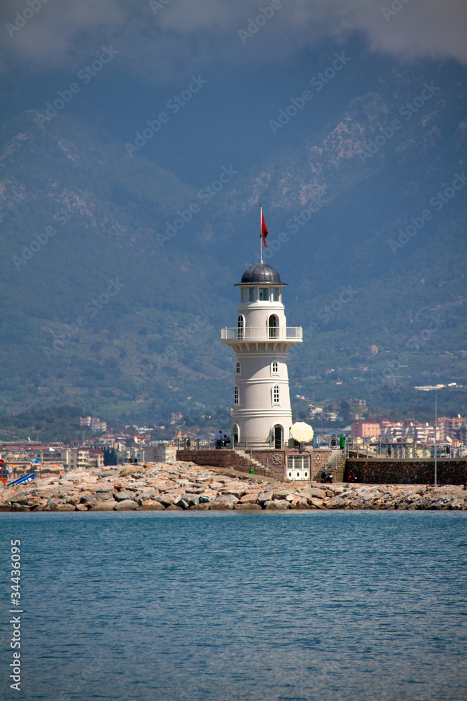 Lighthouse in port. Turkey, Alanya. Sunny weather