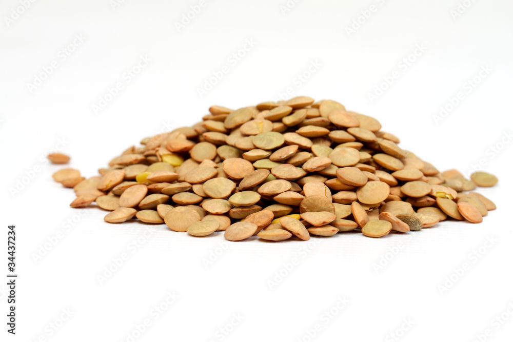 Pile of green lentils from low perspective isolated on white. Pile of green lentils from low perspective isolated on white.
