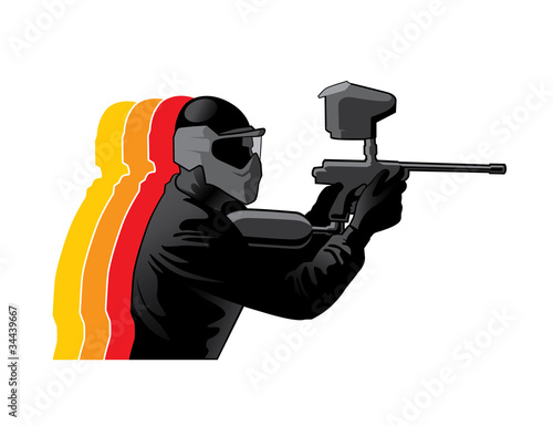 Paintball player in black uniform with marker gun