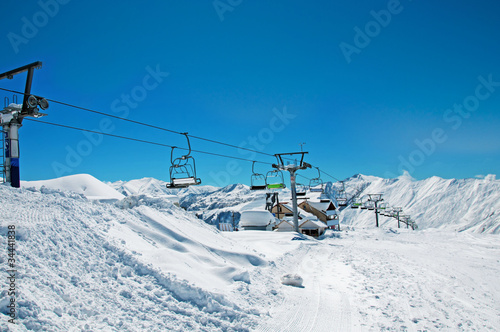 Ski lift chairs on bright winter day