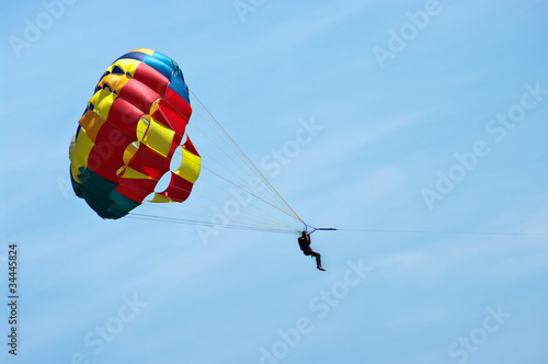 Silhouette of man with parachute on the sky