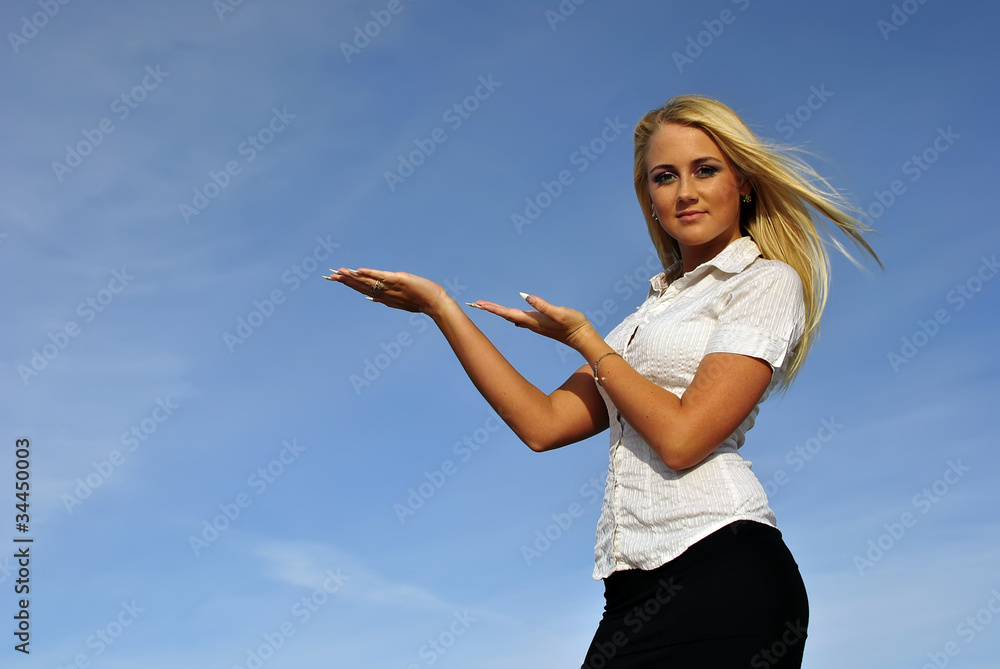 Blonde girl in a white shirt against the sky. Space for text Blonde girl in a white shirt against the sky. Space for text