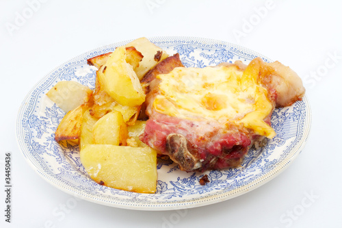 Grilled steak meat with cheese sauce and potatoes