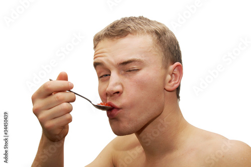young man eating red caviar