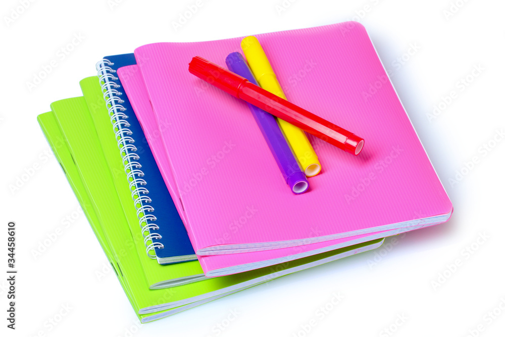 bright notebooks and markers isolated on white bright notebooks and markers isolated on white