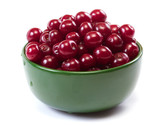 Bowl with ripe cherries. Isolated on a white background.