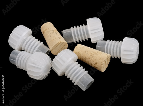 Plastic and wood corks for home wine making, isolated on black