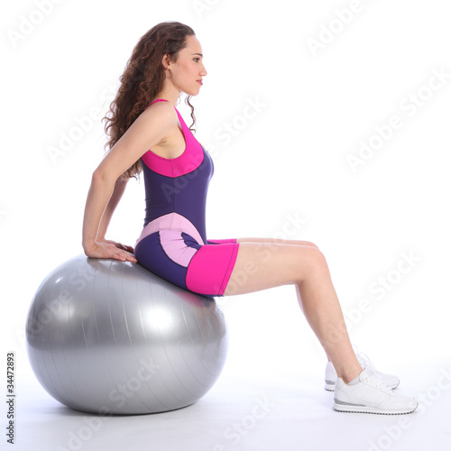 Sexy young woman using ball for balance exercise