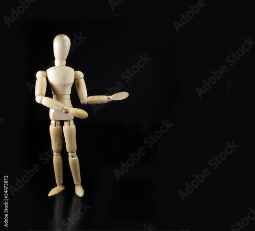 humanoid doll says something with a black background