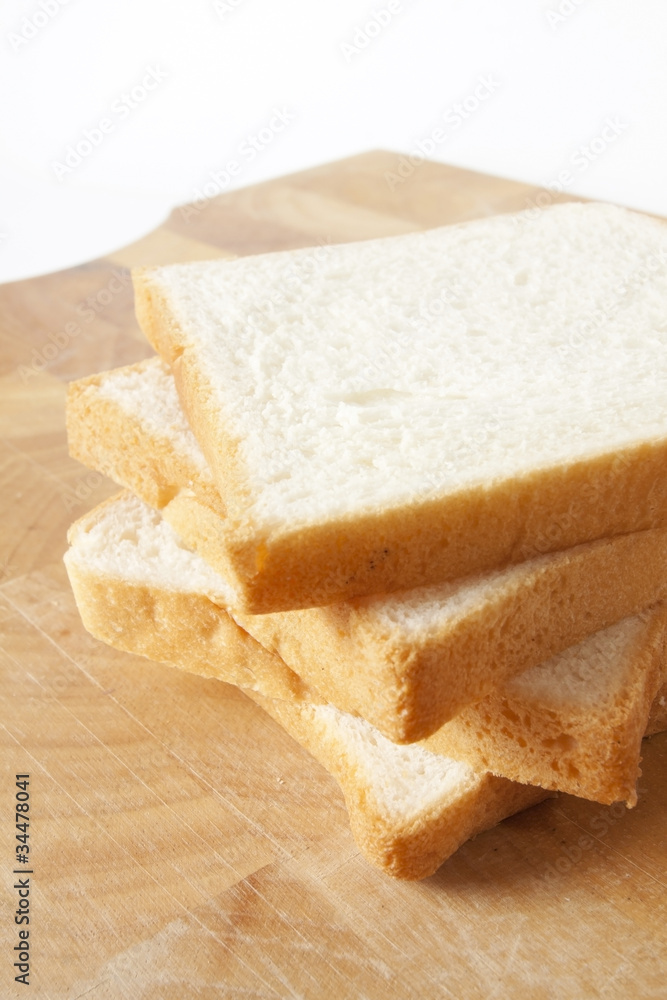 white bread, sliced white bread on wood plate.