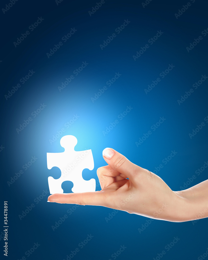 human hand with a piece of puzzle human hand with a piece of puzzle