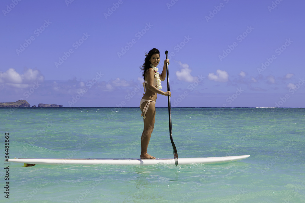 polynesian girl on a standup paddle board