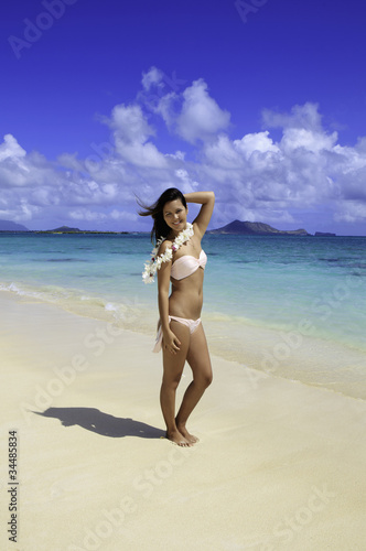 beautiful polynesian girl in a pink bikini on a hawaii beach