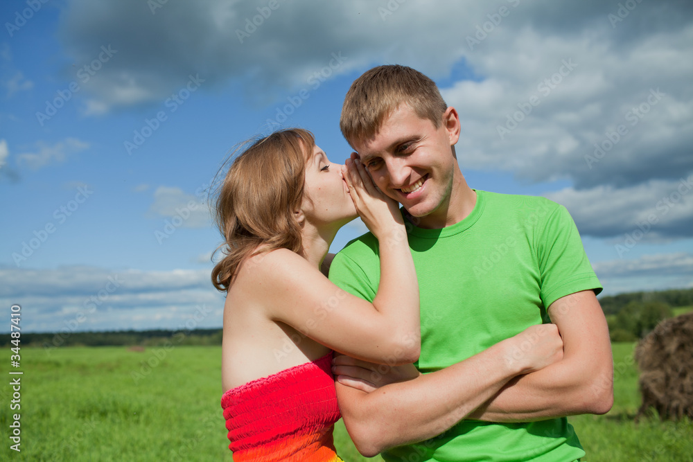 girl is whispering in the ear of the guy girl is whispering in the ear of the guy