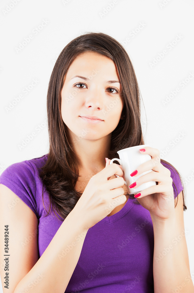 Cute woman drinking a coffee sitting on her bed. Cute woman drinking a coffee sitting on her bed.