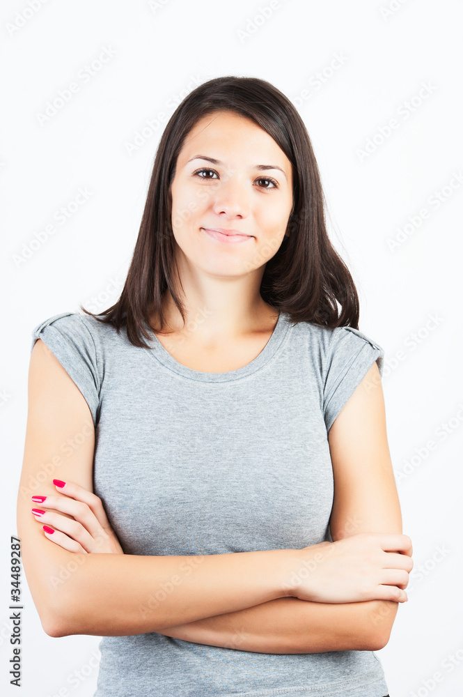 Portrait of gorgeous young woman standing with hands folded over Portrait of gorgeous young woman standing with hands folded over