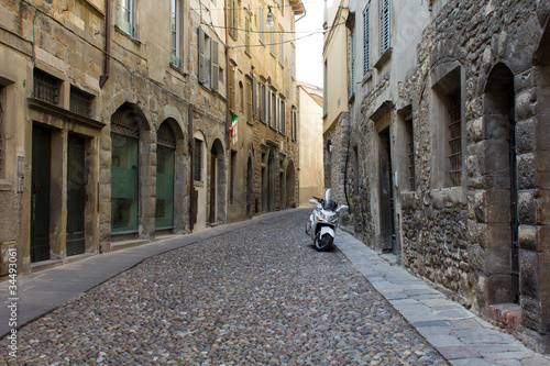 Motorcycle parked in a narrow Italian street