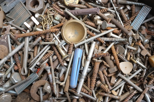 Rusty old wood screws in a handyman's tin.