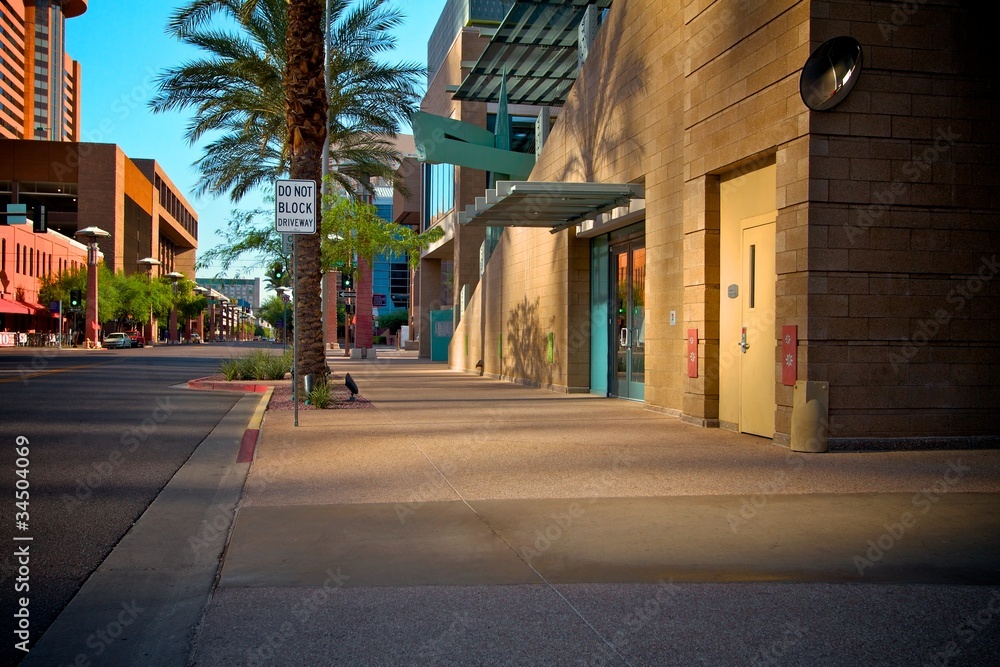 Fototapeta premium Downtown Sidewalk with Reflective Light