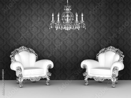 Luxurious armchairs in baroque interior. Ornament wallpapers.