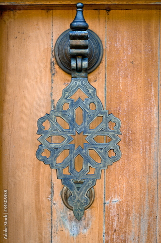 The door handle in the Oriental style. Toning. Vignetting. photo