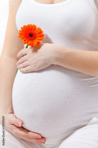 Pregnant woman touching here belly