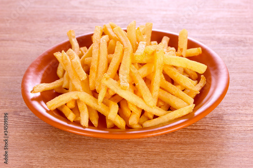 French fries on wooden background