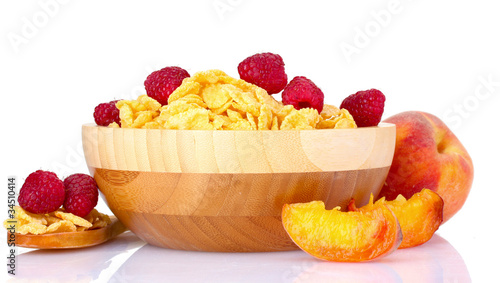 tasty cornflakes and fruit in wooden bowl isolated on white