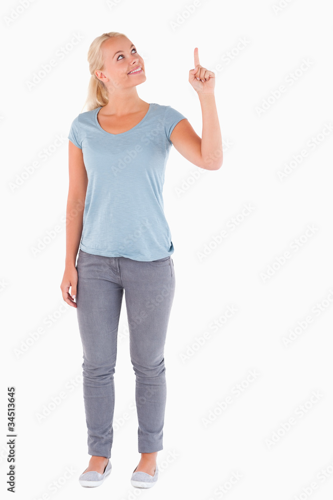 Smiling woman pointing at copyspace Smiling woman pointing at copyspace