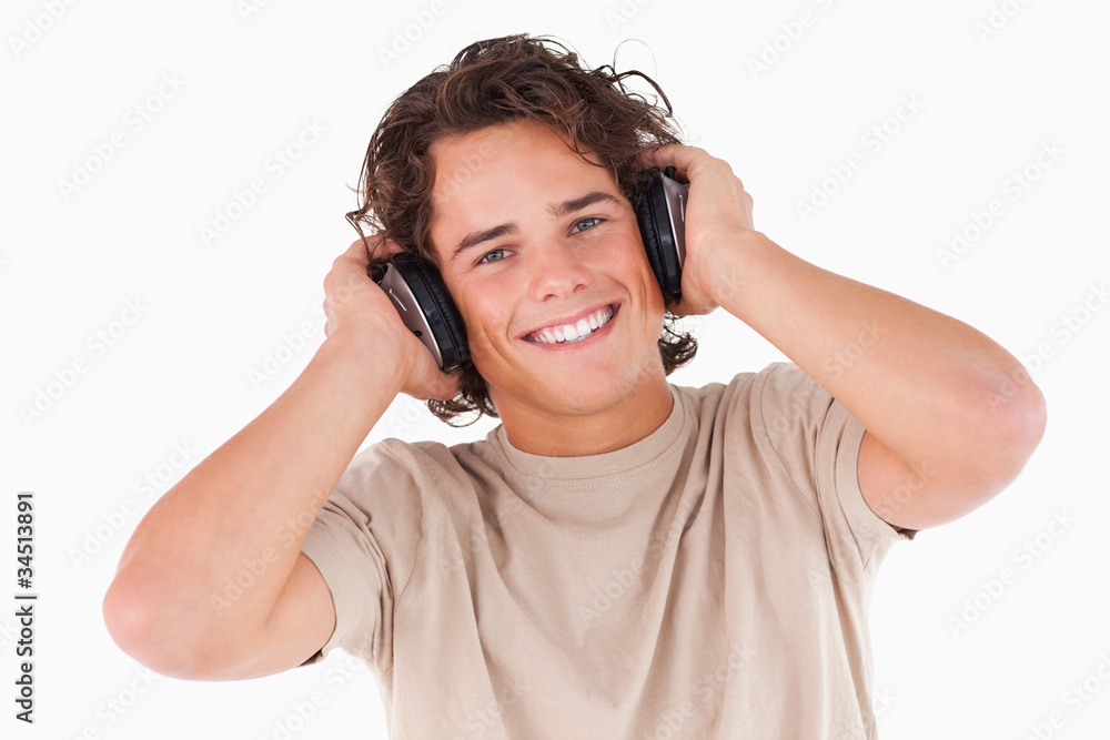 Smiling man with headphones looking into the camera Smiling man with headphones looking into the camera