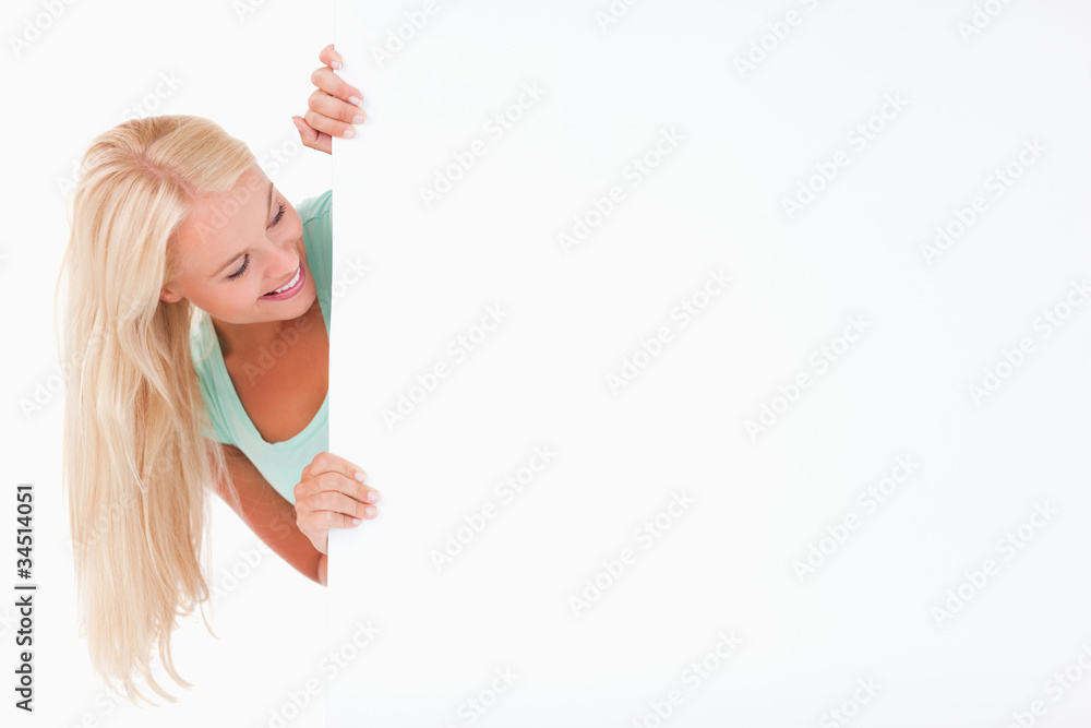 Blond Woman smiling at a whiteboard Blond Woman smiling at a whiteboard