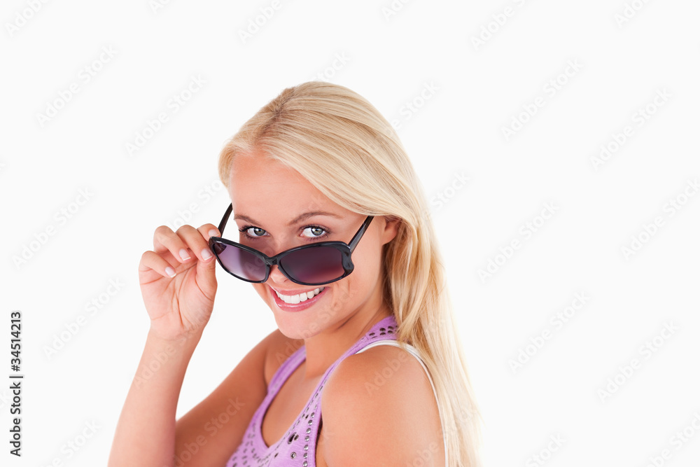 Blond lady peeking over her sunglasses Blond lady peeking over her sunglasses