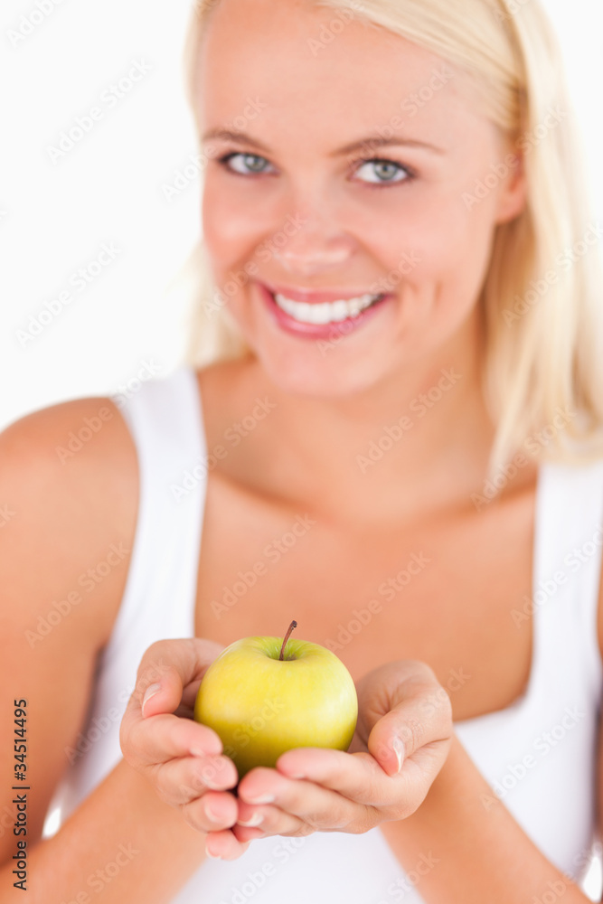 Charming blond woman holding an apple Charming blond woman holding an apple
