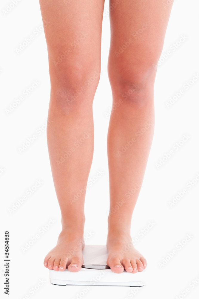 Lady standing on a scale Lady standing on a scale