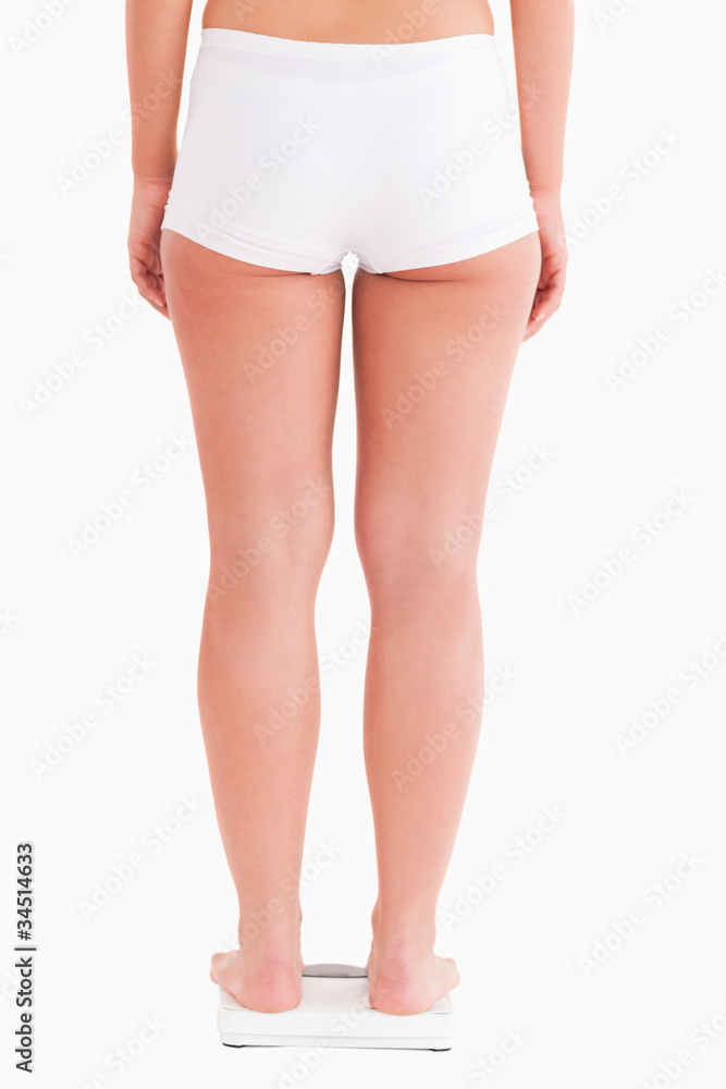 Fit woman standing on a scale Fit woman standing on a scale