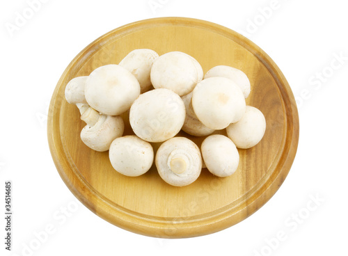 Fresh mushrooms on wooden cutting board isolated