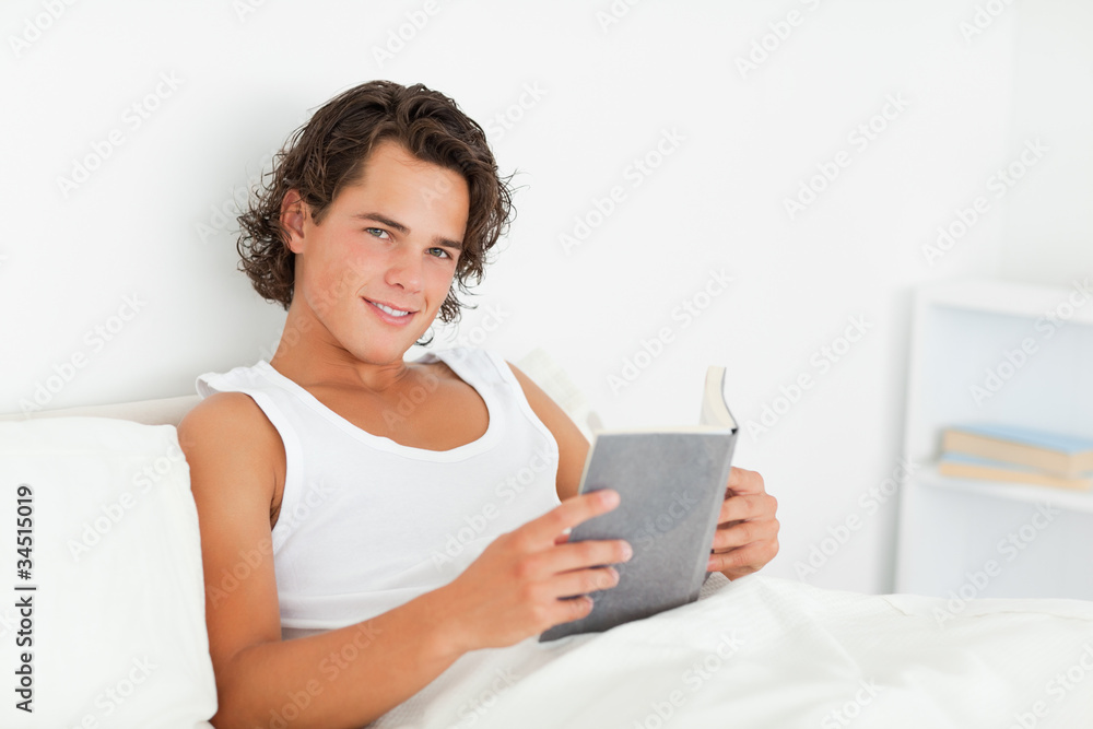 Dark-haired man holding a book Dark-haired man holding a book