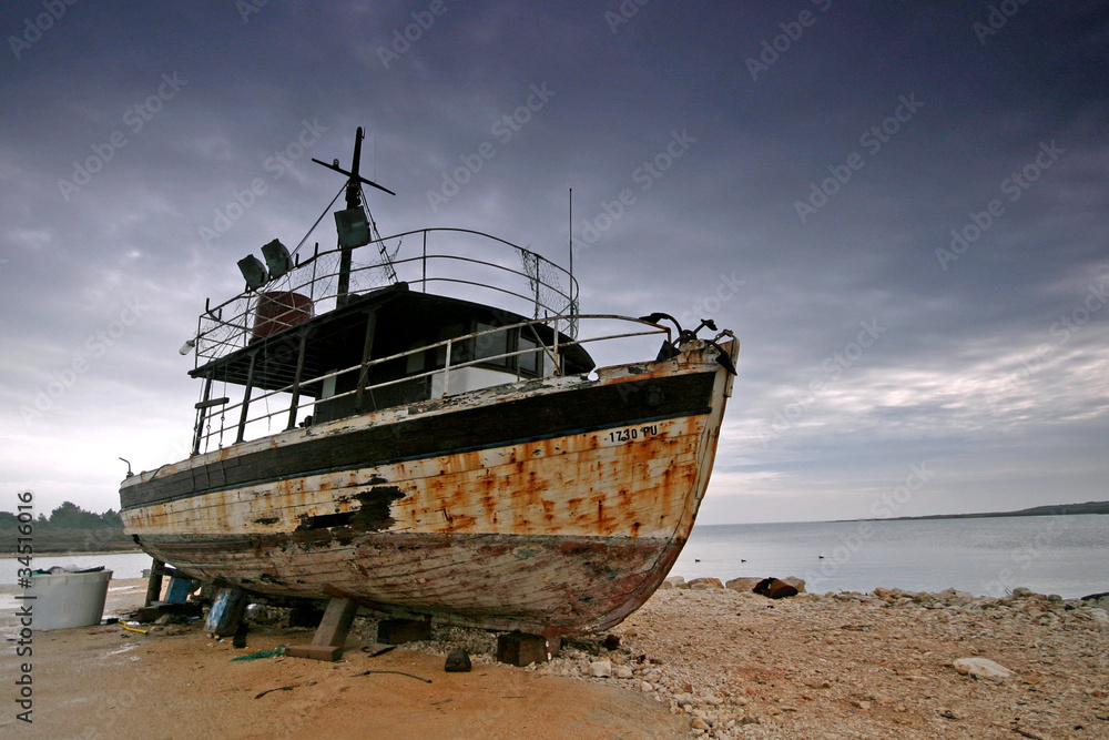 Rusty old ship docked on the coast