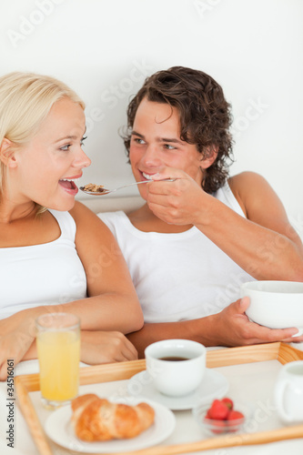 Portrait of a cute couple eating breakfast