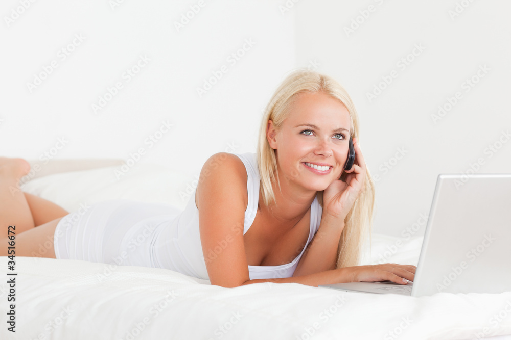 Smiling woman on the phone with a notebook Smiling woman on the phone with a notebook