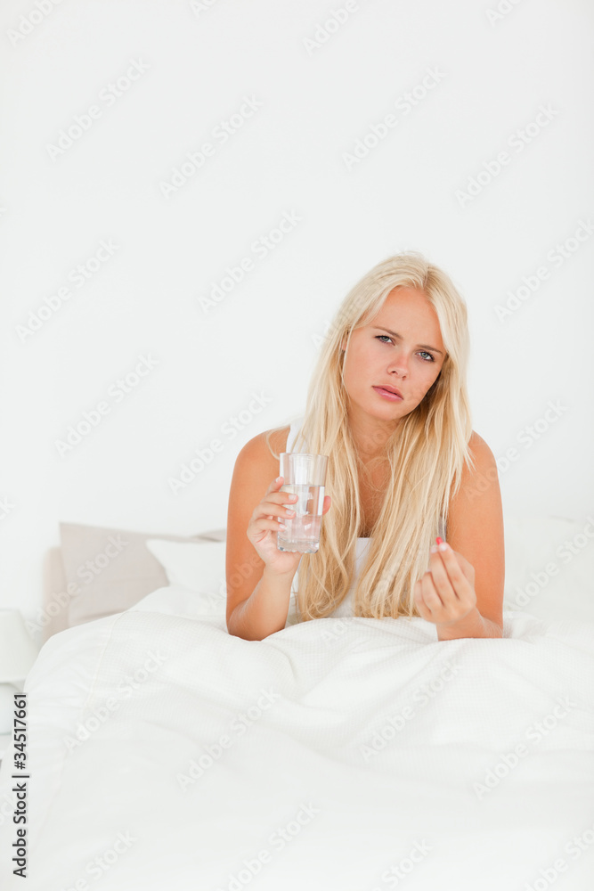 Portrait of a sick woman taking her medication Portrait of a sick woman taking her medication